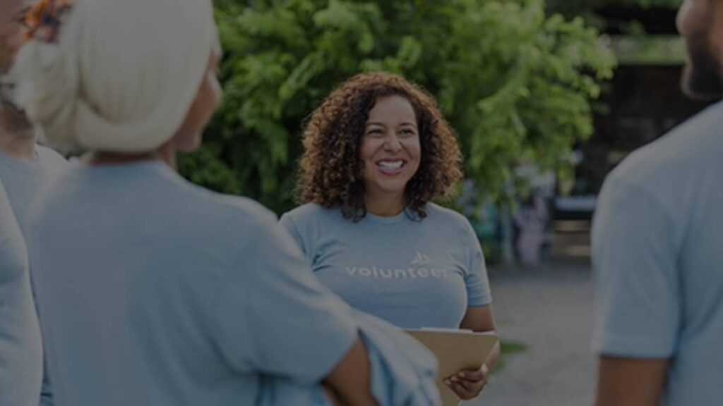 Team of volunteers wearing light blue volunteer t-shirts