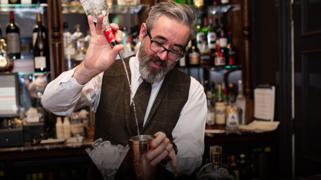 Image of the bar tender making a cocktail