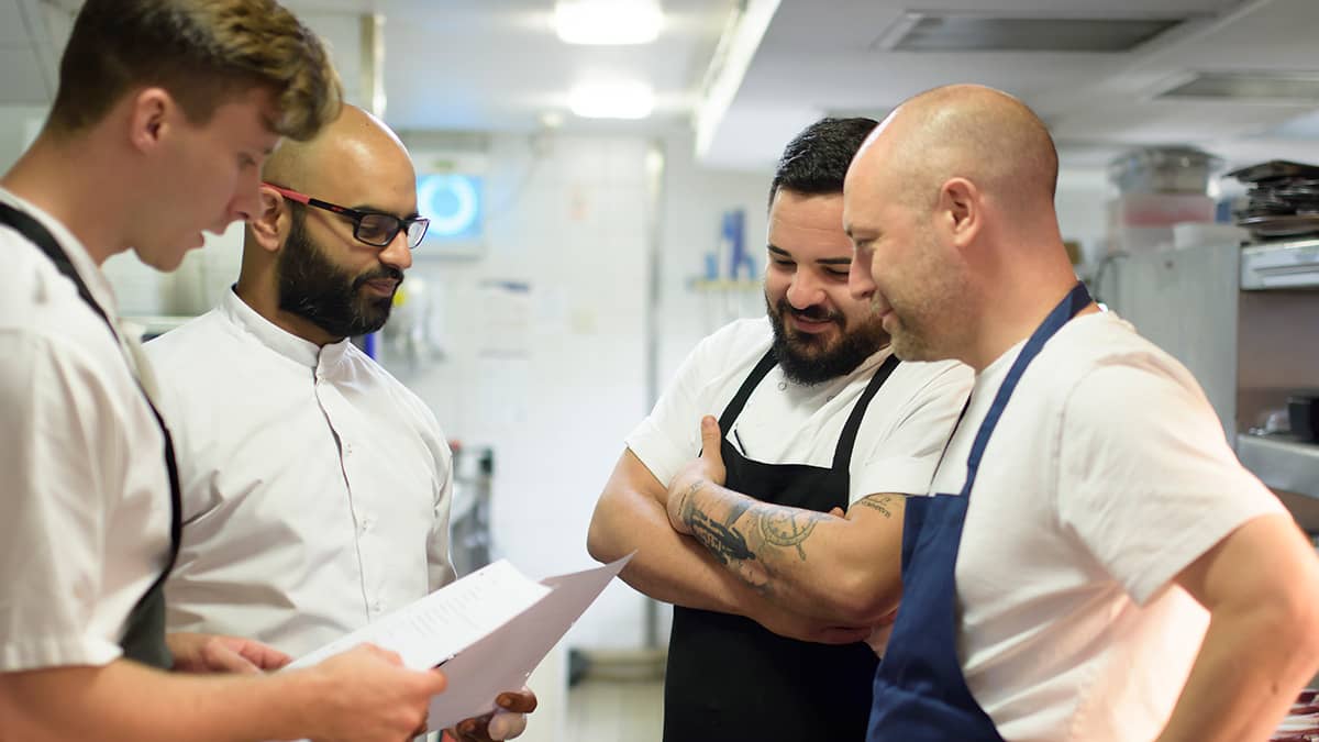 Four chefs in a kitchen