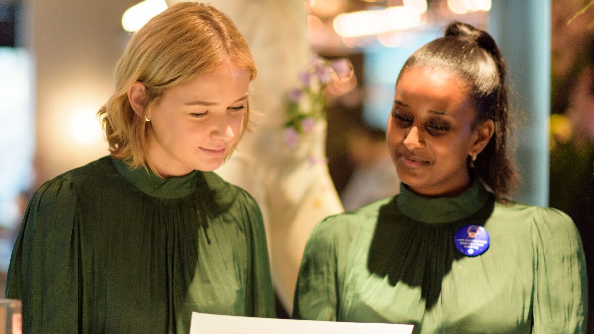 Two women looking at a document at the hotel reception desk