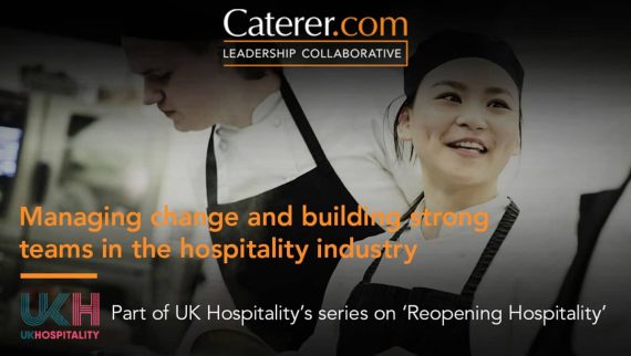 Female chef in kitchen setting speaking to her colleague.