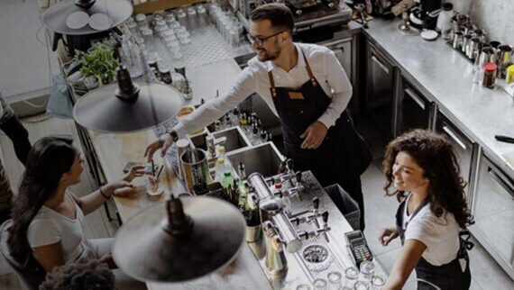 Image of two people working in a bar