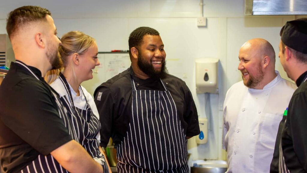 Image of chefs having a conversation back of house